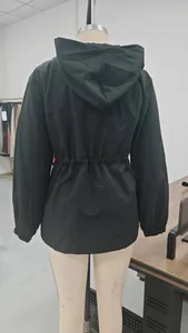 Detail view of black waterproof mountaineering jacket back on mannequin