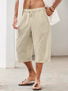 Detailed view of beige cotton-linen men's beach shorts with pockets and drawstring waist
