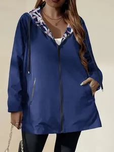 Detail view of a lightweight blue hooded windbreaker jacket for women with floral lining