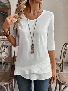 Casual white textured crew neck blouse with a stylish layered asymmetrical hemline