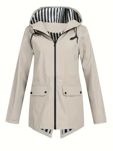 Detail view of lightweight beige women's outdoor windbreaker jacket with striped hood lining