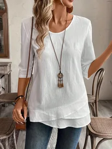 Casual white three-quarter sleeve top with textured fabric and layered hem detail