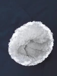Detail showing the soft white sherpa fleece lining of the blue waterproof jacket