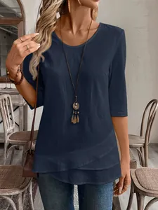 Detailed view of women's navy blue casual top with a unique and stylish layered hem