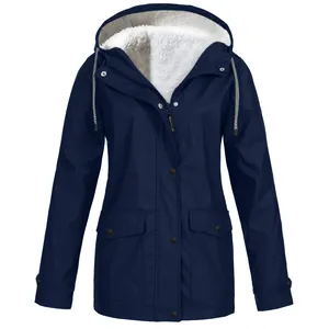 Detail of navy blue hooded winter jacket featuring soft white fleece lining and pockets