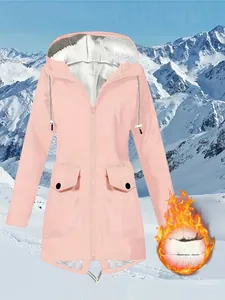Close-up of pink women's waterproof mountain jacket with warm fleece lining detail