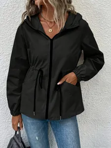 Detail view of a black hooded waterproof windbreaker with adjustable drawstring waist.