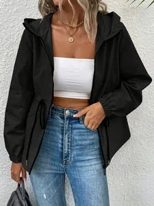 Detail view of women's black waterproof outdoor hooded jacket with drawstring waist