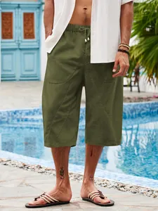 Full view of men's casual olive green cotton-linen beach shorts with a multi-pocket design
