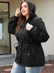 Women's black waterproof hooded windbreaker with drawstring waist in outdoor setting