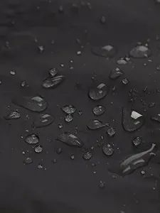 Close-up detail of waterproof fabric with water droplets for outdoor jacket