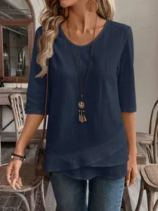 Detailed view showing the navy blue layered asymmetric hem of a casual cotton-linen top