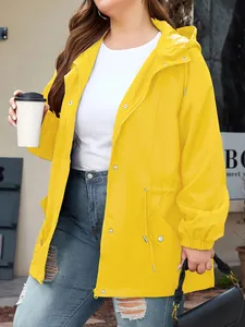Detail view of a bright yellow waterproof outdoor hooded jacket for women