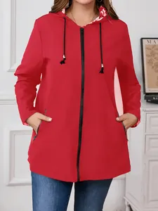 Detail of women's red lightweight hooded windbreaker with full zipper and pockets