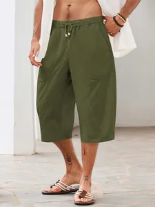 Detail of men's olive green cotton linen casual beach shorts with multiple pockets.