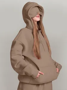 Detailed view of women's oversized solid hoodie featuring unique built-in eye cover design