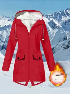 Close-up detail of women's red hiking jacket showing warm white fleece lining with flame graphic