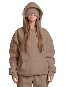 Detail of oversized taupe hoodie with innovative built-in sleep mask on hood design