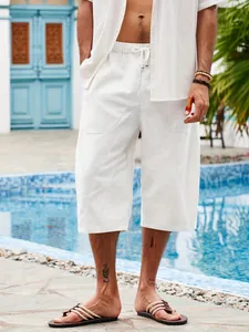 Detail shot of white cotton-linen men's casual beach shorts with pockets at poolside