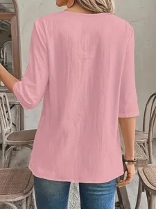 Back view detail of a casual pink textured women's blouse with three-quarter sleeves