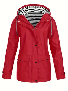 Détail d'un imperméable rouge pour femme avec doublure de capuche rayée et poches à pression