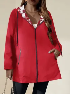 Detail view of women's lightweight red hooded windbreaker with floral lining detail