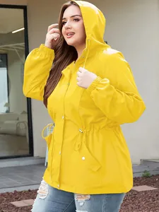 Detail of women's bright yellow waterproof outdoor jacket with drawstring waist and hood
