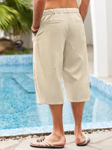 Back view detail of men's casual cotton linen beach shorts in beige showing fabric