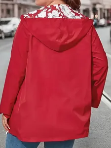 Back view of a lightweight red hooded windbreaker jacket with white floral shoulder pattern