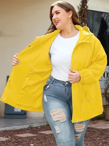 Detail of bright yellow waterproof outdoor jacket with hood and functional pockets