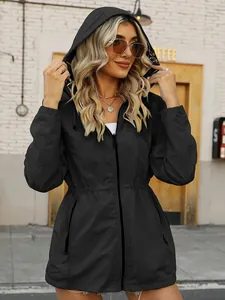 Detailed shot of women's black waterproof windbreaker with adjustable waist and hood