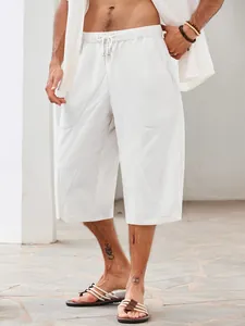 Detailed shot of premium white cotton-linen beach shorts featuring large side pockets.
