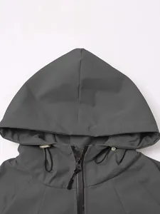 Close-up detail of the adjustable hood and zipper on a grey outdoor windbreaker jacket.
