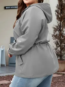 Side view of a gray women's waterproof hooded windbreaker with drawstring waist.