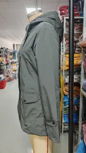 Close-up side profile detail of a gray waterproof outdoor hooded windbreaker jacket