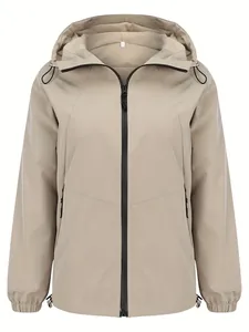 Front view detail of a women's lightweight beige hooded windbreaker with zipper