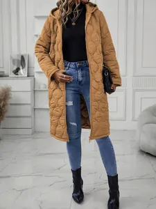 Full-body shot of a stylish mustard yellow long hooded quilted jacket for women