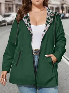 Front view of women's green lightweight hooded windbreaker jacket with floral lining