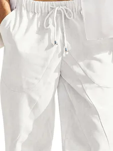 Close-up of men's white cotton linen casual pants with drawstring and texture detail