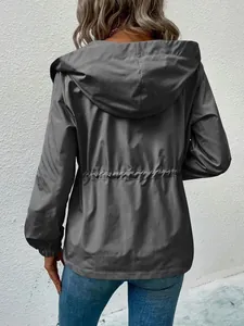 Detailed back view of a dark grey waterproof hooded windbreaker outdoor jacket for women