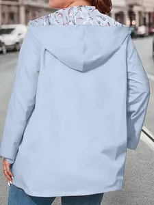 Back view of a women's lightweight light blue windbreaker jacket with hooded design.