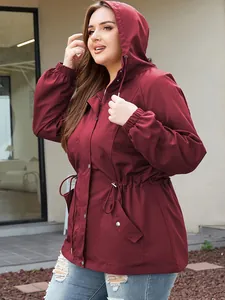 Detail view of women's burgundy hooded windbreaker with drawstring waist and pockets