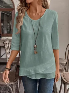Detail showing texture of women's mint green short sleeve top with layered asymmetrical hem