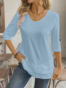 Detailed view showing the layered hem and fabric texture of a light blue casual women's top