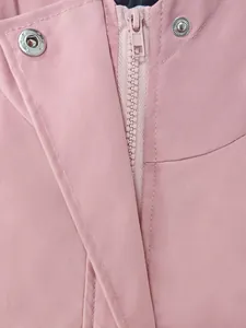 Detail of pink waterproof outdoor hiking jacket with zipper and snap buttons