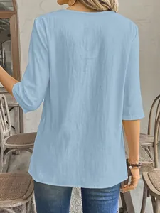 Back view of light blue linen-textured casual blouse with mid-length sleeves