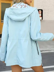 Back view of a light blue waterproof windbreaker with hood and adjustable drawstring waist.