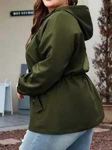 Side view of a women's olive green waterproof hooded storm jacket outdoor.