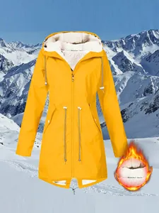 Detailed view of yellow hooded outdoor jacket with warm white fleece lining texture
