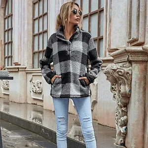 Outdoor street style view of a women's plaid fleece pullover with button collar